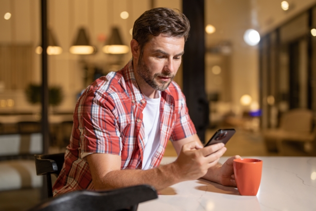 A borrower reviews personal loan options for bad credit on his smartphone.