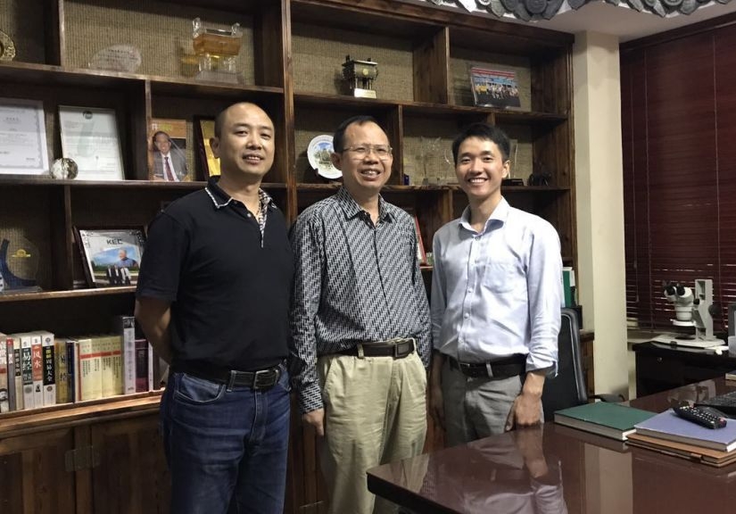 Dr. Zhu (center) and his microscope