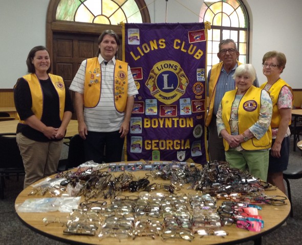 Randall Franks (second from left) join with fellow Lions in recycling eyeglasses.